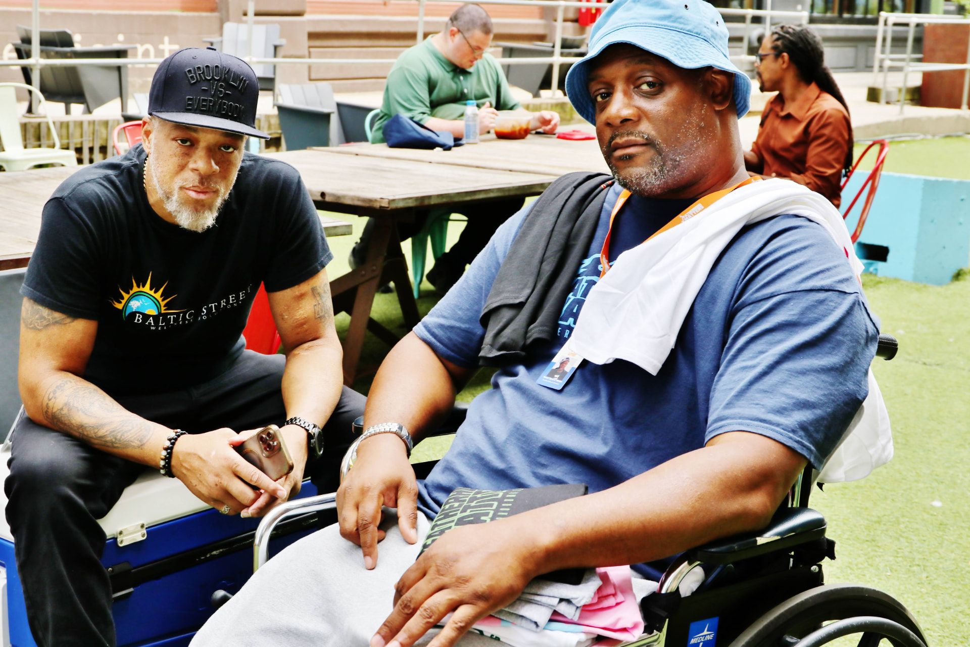 Two men talking at a Baltic Street community event