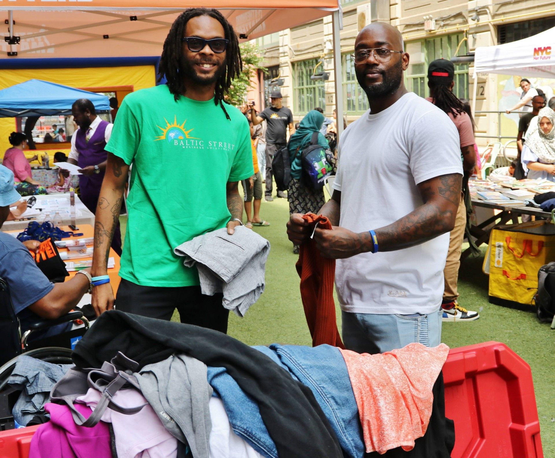Baltic Street team members handing out clothing at an outdoor community event